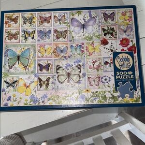 This is a "Butterfly Tiles" jigsaw puzzle manufactured by Cobble Hill Puzzles